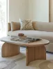 wooden coffee table, placed in a living room, beige coloured sofa, cushions, rug