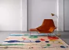 beautiful rug placed in living room, a chair with fabric upholstery