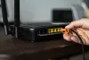 man-plugging-ethernet-cable-wireless-router.jpg