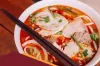 How Is the Spicy Chicken Noodle Soup Made in the Pho Restaurants?