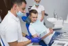 dentist-patient-smiling-looking-radiography-min.jpg