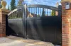 elegant-black-double-swing-gate-with-vertical-metal-bars-creating-a-grand-entrance-crafted-by-gates-wellington.webp