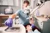 male-dentist-grabbing-dental-explorer-dental-procedure-min-scaled.jpg